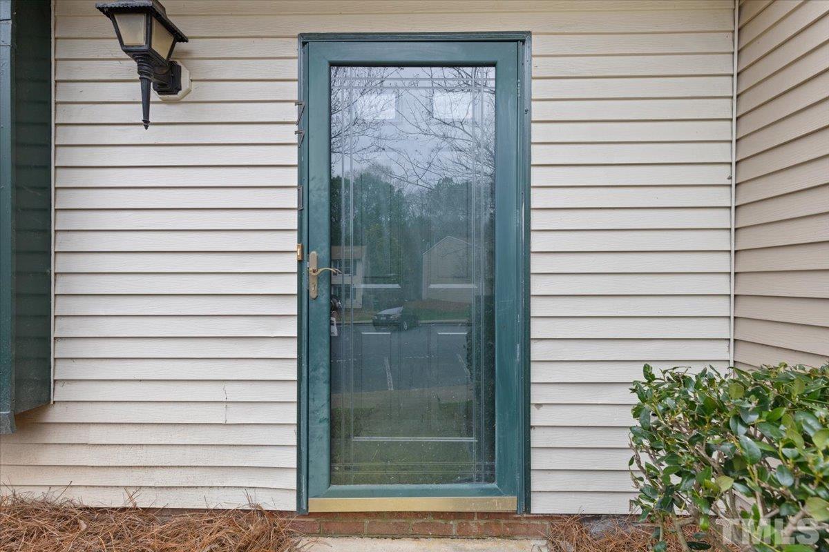7721 Sandra Lane Raleigh, NC 27615 - Photo 3 of 29 a view of a back yard of a house with a door