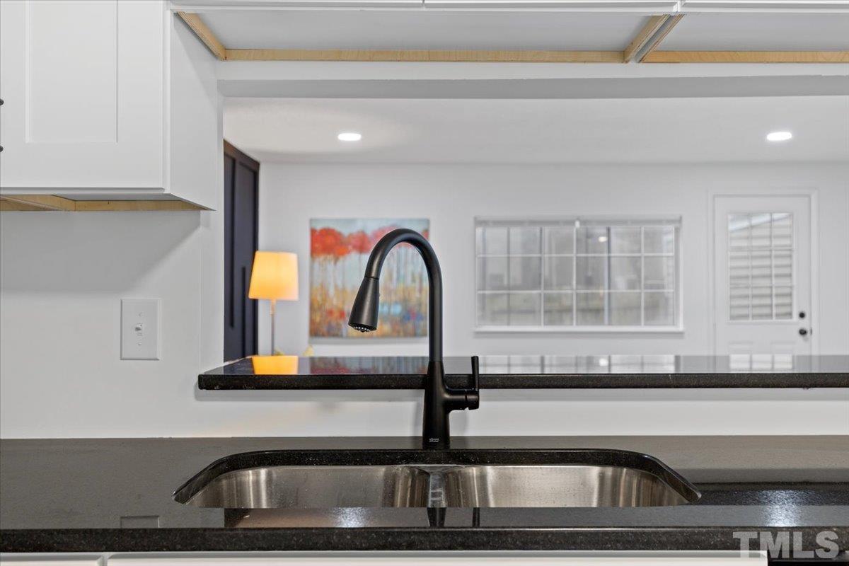 7721 Sandra Lane Raleigh, NC 27615 - Photo 8 of 29 a kitchen with a sink and a window