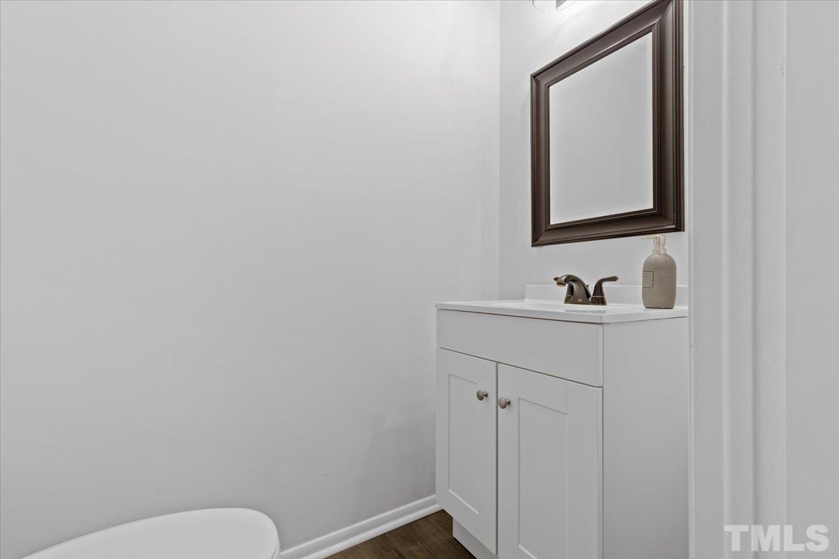 7721 Sandra Lane Raleigh, NC 27615 - Photo 9 of 29 a bathroom with a toilet sink and mirror