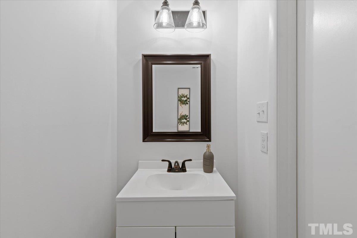 7721 Sandra Lane Raleigh, NC 27615 - Photo 10 of 29 a bathroom with a sink and a mirror