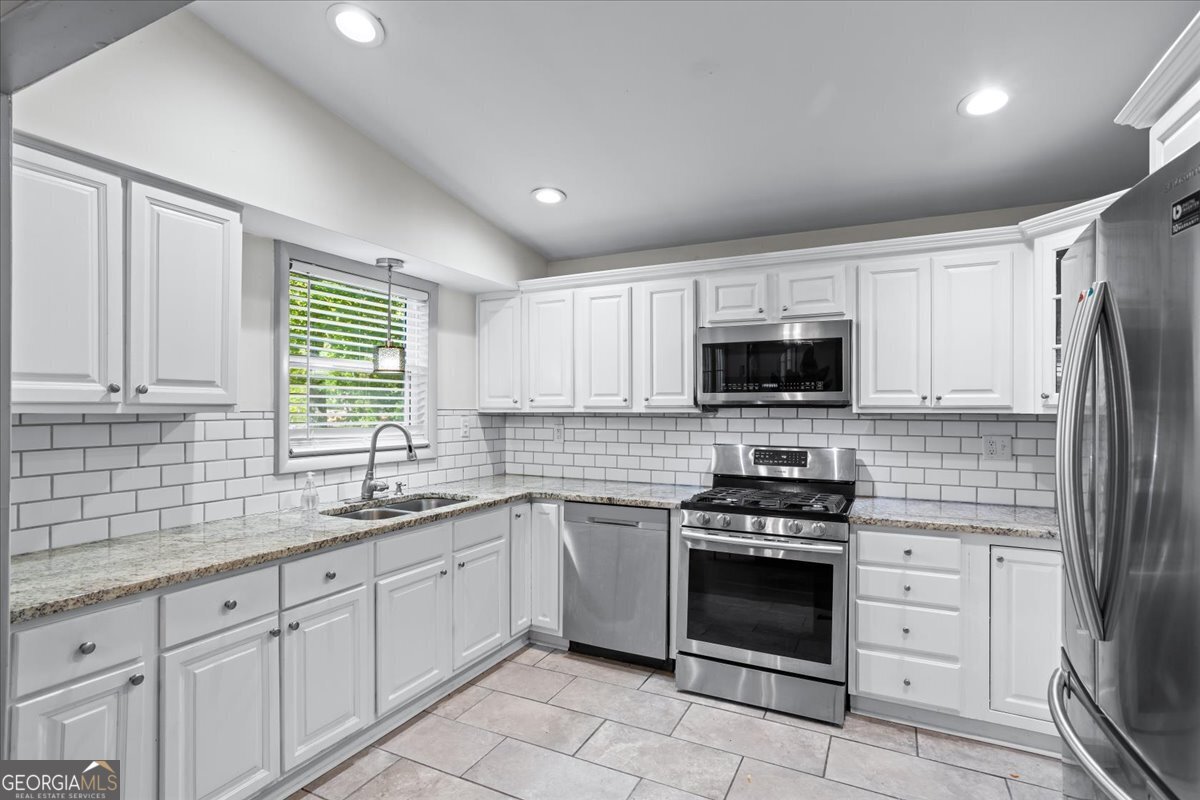 2316 Dorsey Avenue East Point, GA 30344 - Photo 12 of 25 a kitchen with cabinets stainless steel appliances and a window