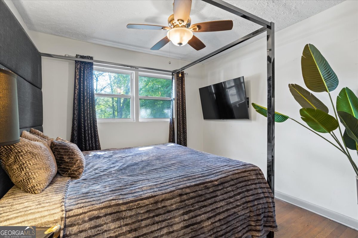 2316 Dorsey Avenue East Point, GA 30344 - Photo 17 of 25 a bedroom with a bed window and a flat screen tv