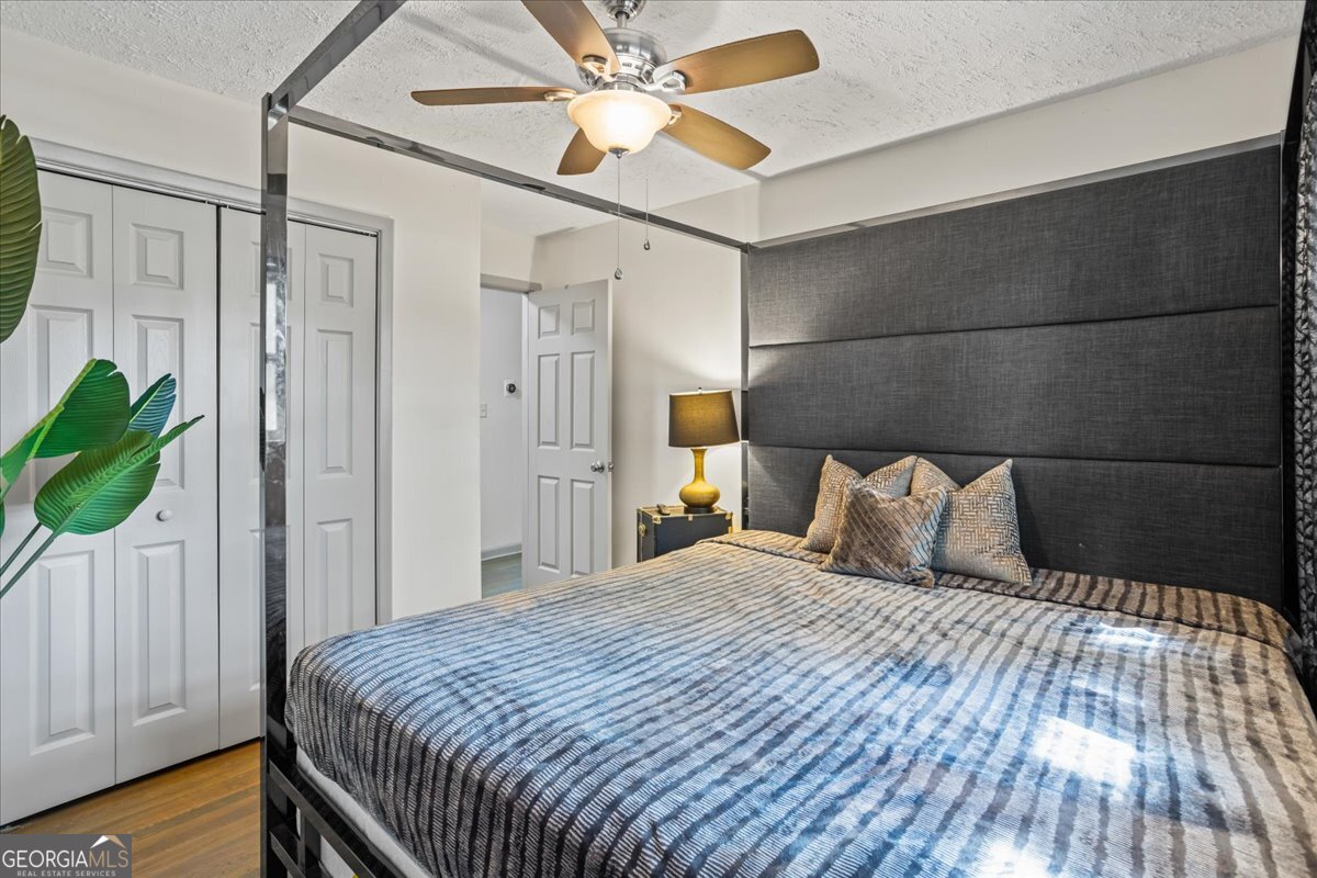 2316 Dorsey Avenue East Point, GA 30344 - Photo 18 of 25 a bedroom with a bed and a chandelier