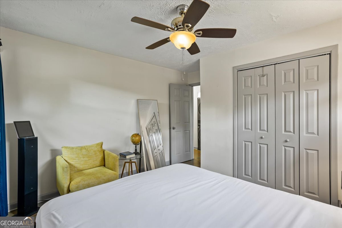 2316 Dorsey Avenue East Point, GA 30344 - Photo 20 of 25 a bedroom with a bed and a chandelier
