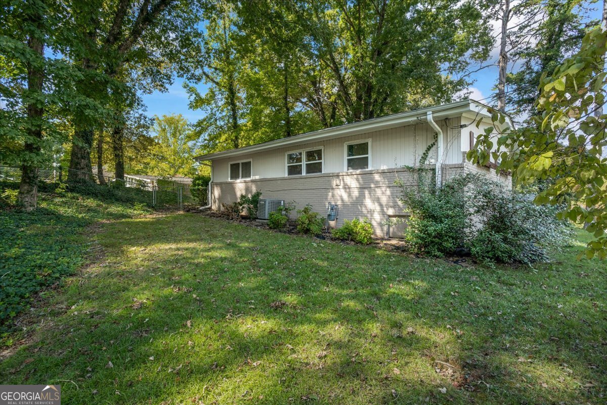 2316 Dorsey Avenue East Point, GA 30344 - Photo 5 of 25 a view of a yard in front of a house with large trees