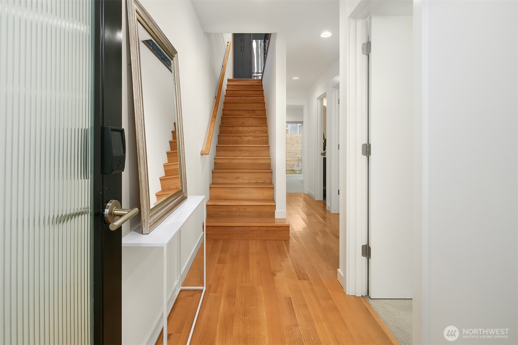 8305 12th Avenue Northwest, Unit C Seattle, WA 98117 - Photo 17 of 26 a view of a hallway with wooden floor and staircase