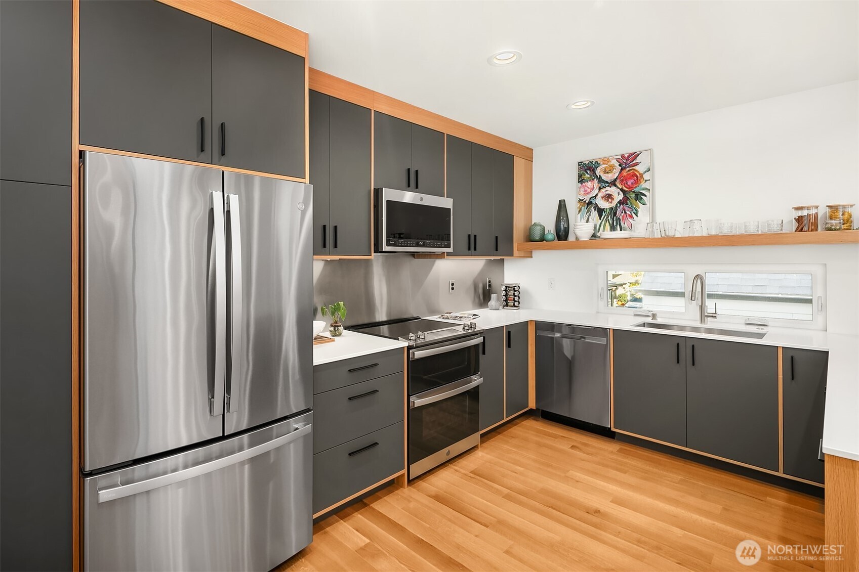8305 12th Avenue Northwest, Unit C Seattle, WA 98117 - Photo 6 of 26 a kitchen with stainless steel appliances granite countertop a refrigerator and a sink