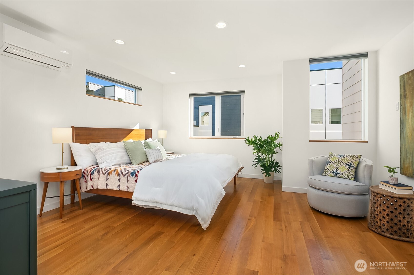 8305 12th Avenue Northwest, Unit C Seattle, WA 98117 - Photo 9 of 26 a spacious bedroom with a bed and a couch