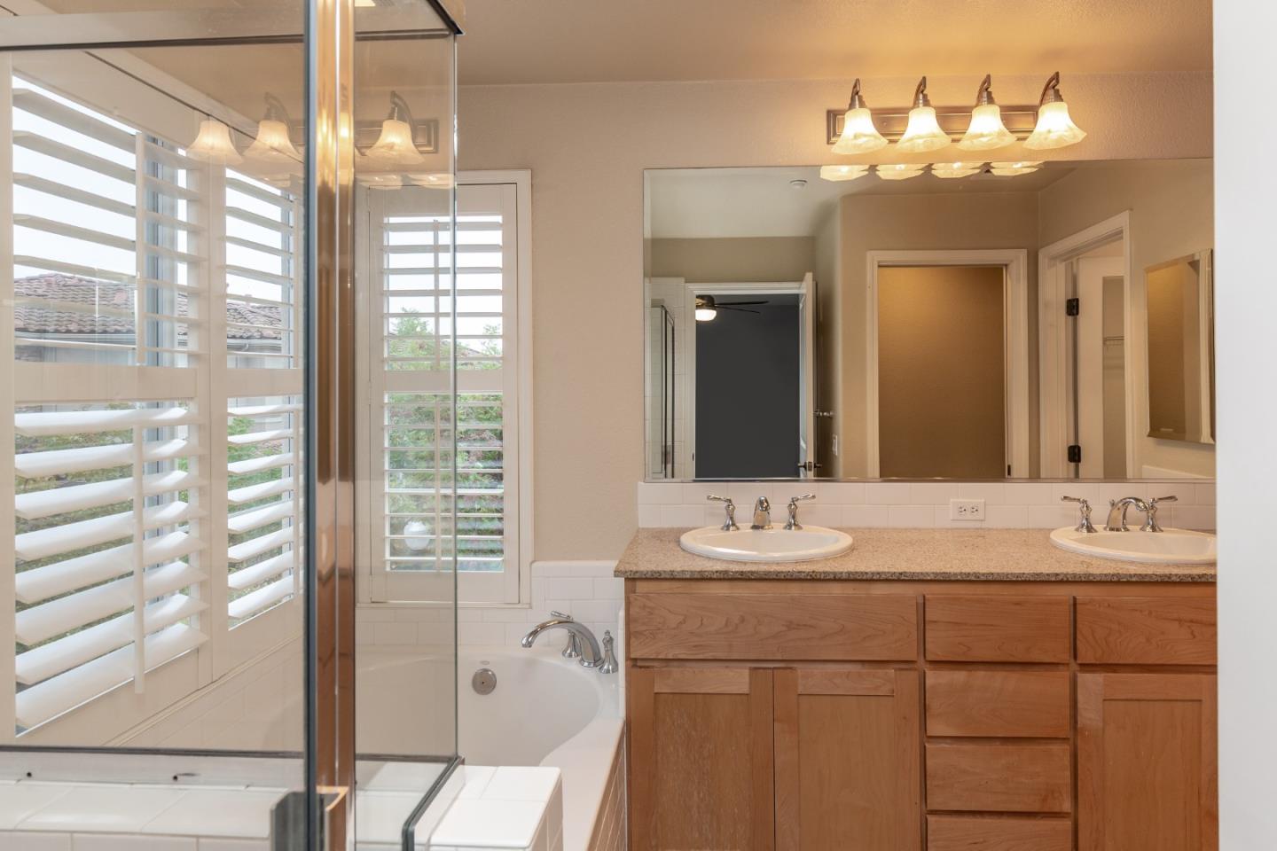 341 Vista Roma Way San Jose, CA 95136 - Photo 12 of 24 a bathroom with a double vanity sink and a mirror