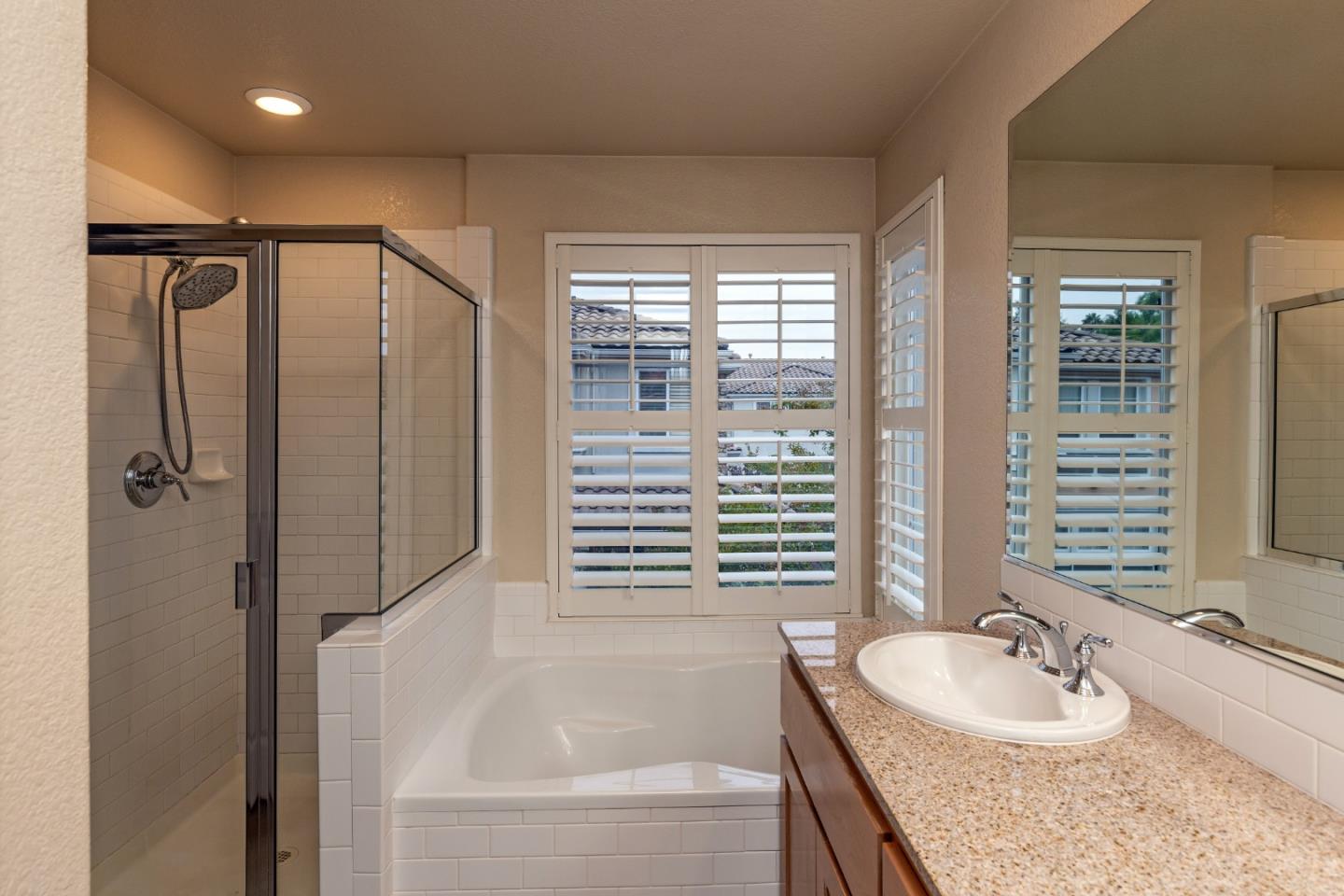 341 Vista Roma Way San Jose, CA 95136 - Photo 13 of 24 a bathroom with a granite countertop sink and a bathtub