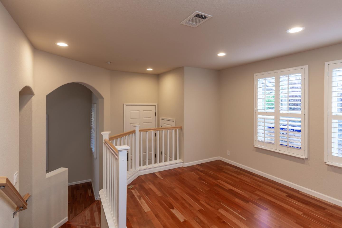 341 Vista Roma Way San Jose, CA 95136 - Photo 5 of 24 a view of a hallway with wooden floor and windows