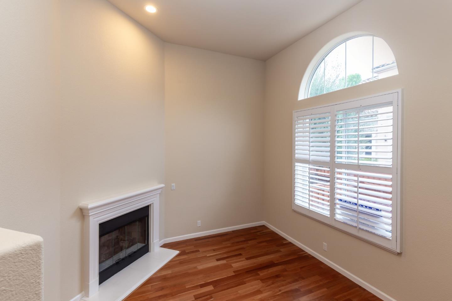 341 Vista Roma Way San Jose, CA 95136 - Photo 6 of 24 a view of an empty room with wooden floor and a window