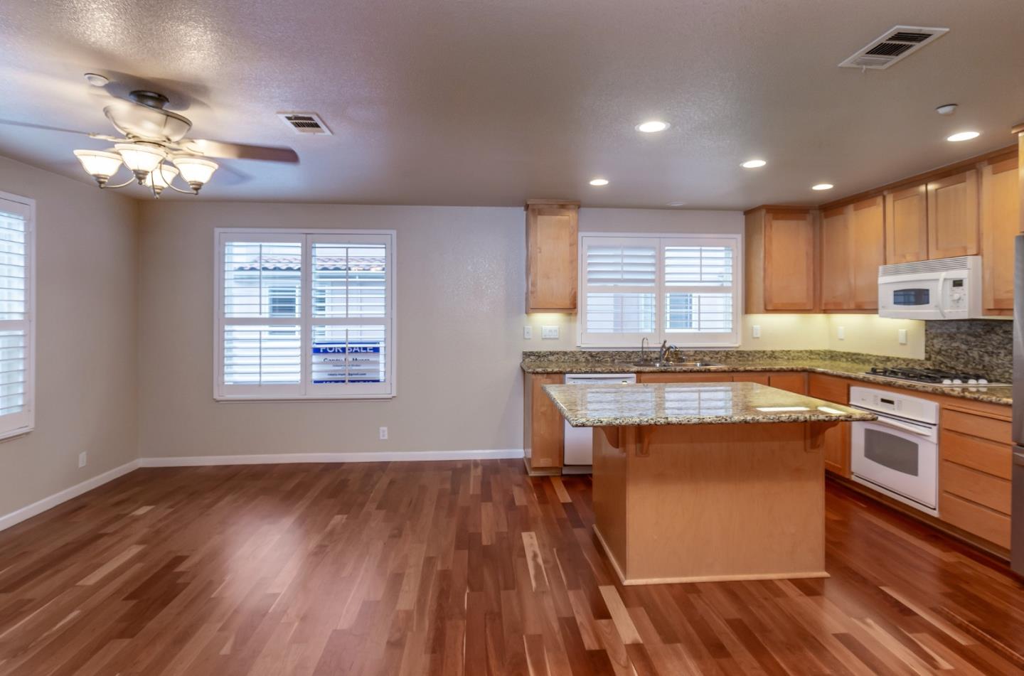 341 Vista Roma Way San Jose, CA 95136 - Photo 7 of 24 a kitchen with a wooden floor and a window