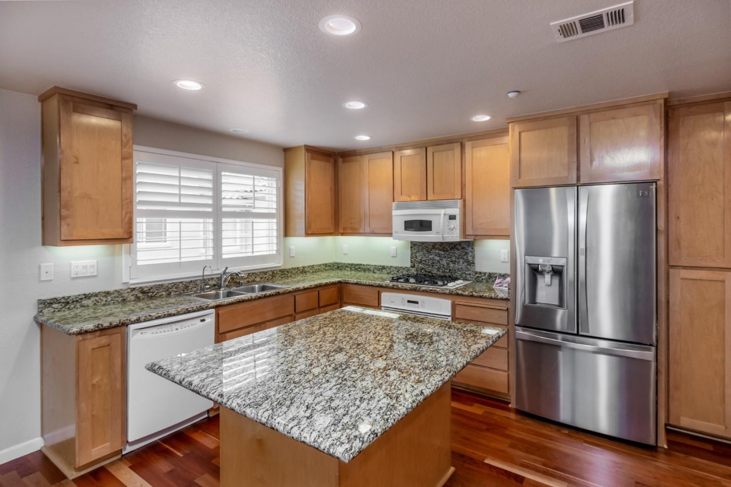 341 Vista Roma Way San Jose, CA 95136 - Photo 8 of 24 a kitchen with stainless steel appliances granite countertop a refrigerator sink and stove