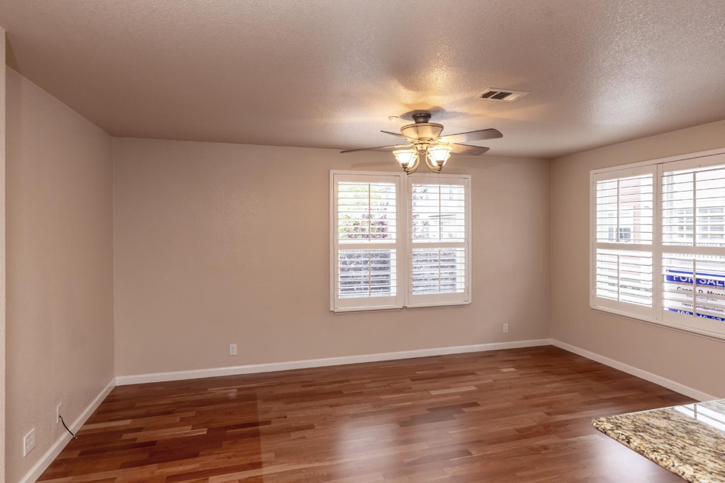 341 Vista Roma Way San Jose, CA 95136 - Photo 9 of 24 a view of an empty room with wooden floor and a window
