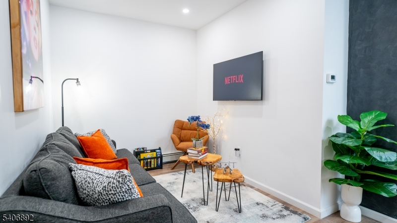 a living room with furniture and a potted plant