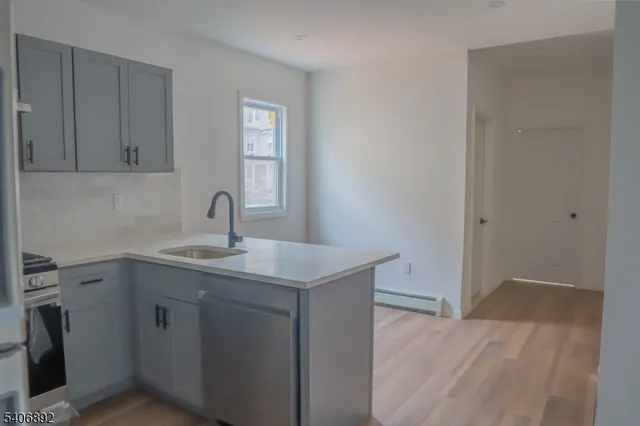 a kitchen with a sink a refrigerator and window