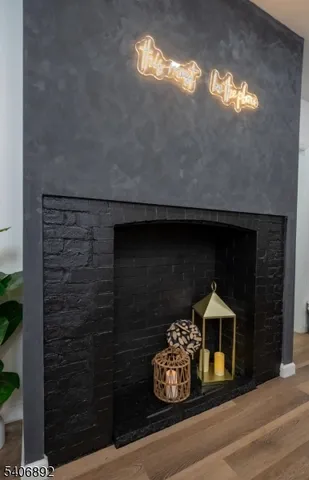 a room with a fireplace and a potted plant