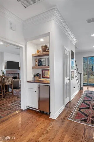 a open kitchen with white cabinets and wooden floor