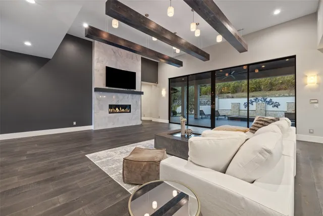 an empty room with wooden floor and a window