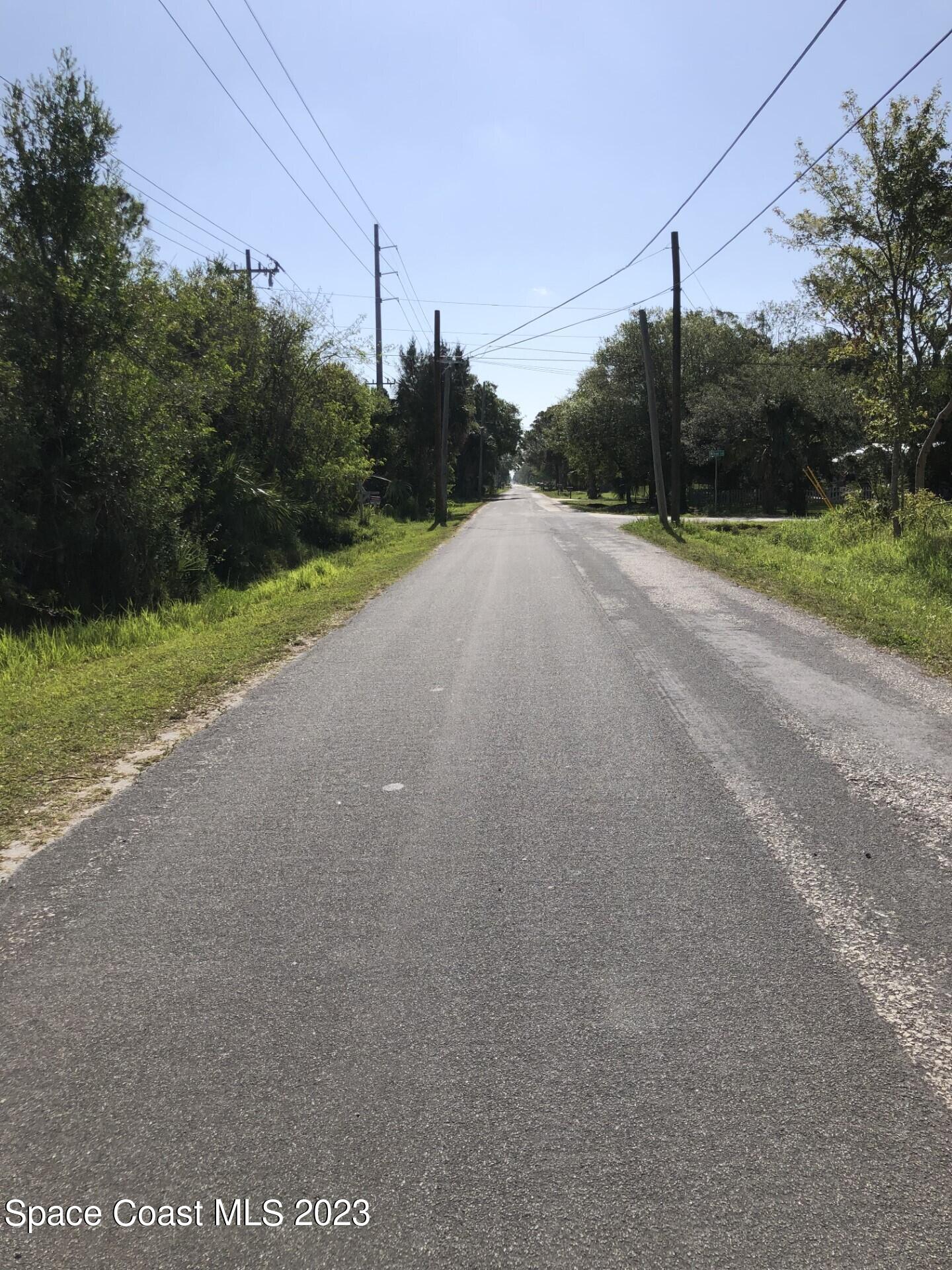 580 Hall Road Malabar, FL 32950 - Photo 3 of 9 a view of a rural road with a building