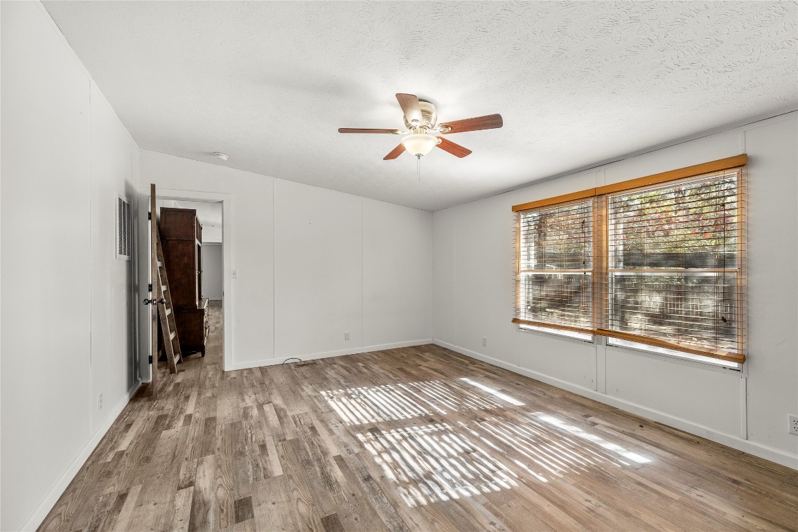 21150 Arnsworth Road Montgomery, TX 77356 - Photo 22 of 35 a view of empty room with wooden floor and fan