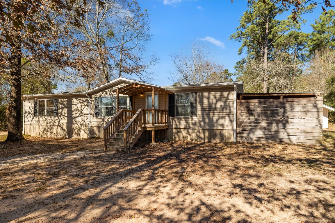 21150 Arnsworth Road Montgomery, TX 77356 - Photo 3 of 35 a view of a house with large trees