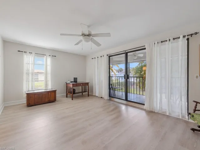 a view of livingroom with furniture fan and windows