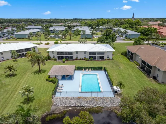 an aerial view of multiple houses with yard