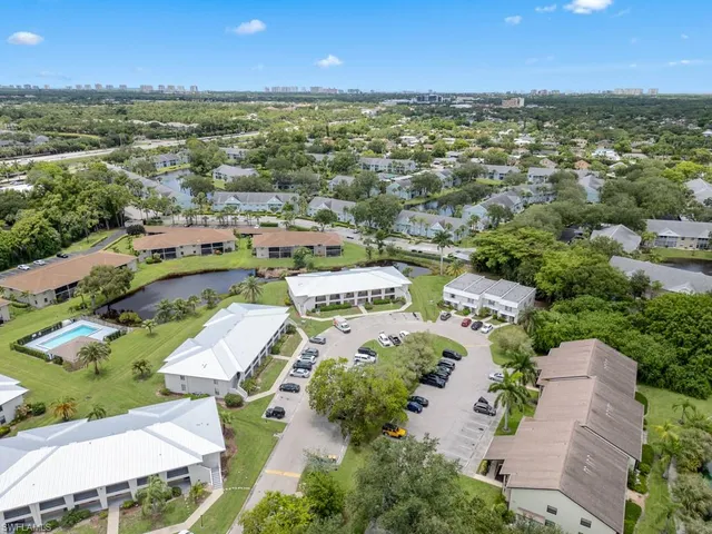 an aerial view of residential houses with outdoor space and ocean view