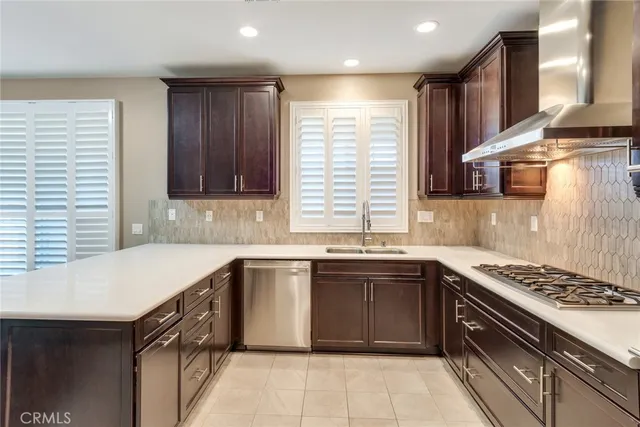 a kitchen with a sink stove top oven and cabinets