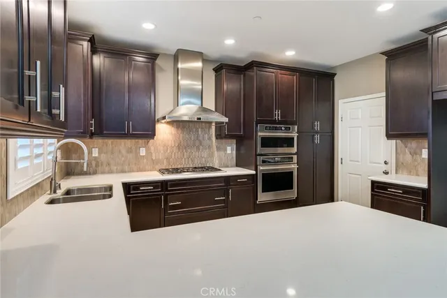 a kitchen with stainless steel appliances granite countertop a stove and a refrigerator