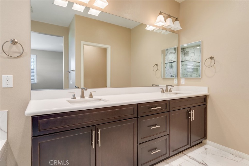 7903 Chaparral Drive Highland, CA 92346 - Photo 18 of 28 a bathroom with a double vanity sink and a mirror