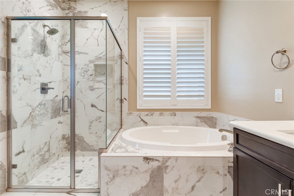 7903 Chaparral Drive Highland, CA 92346 - Photo 19 of 28 a bathroom with a granite countertop sink and a bathtub