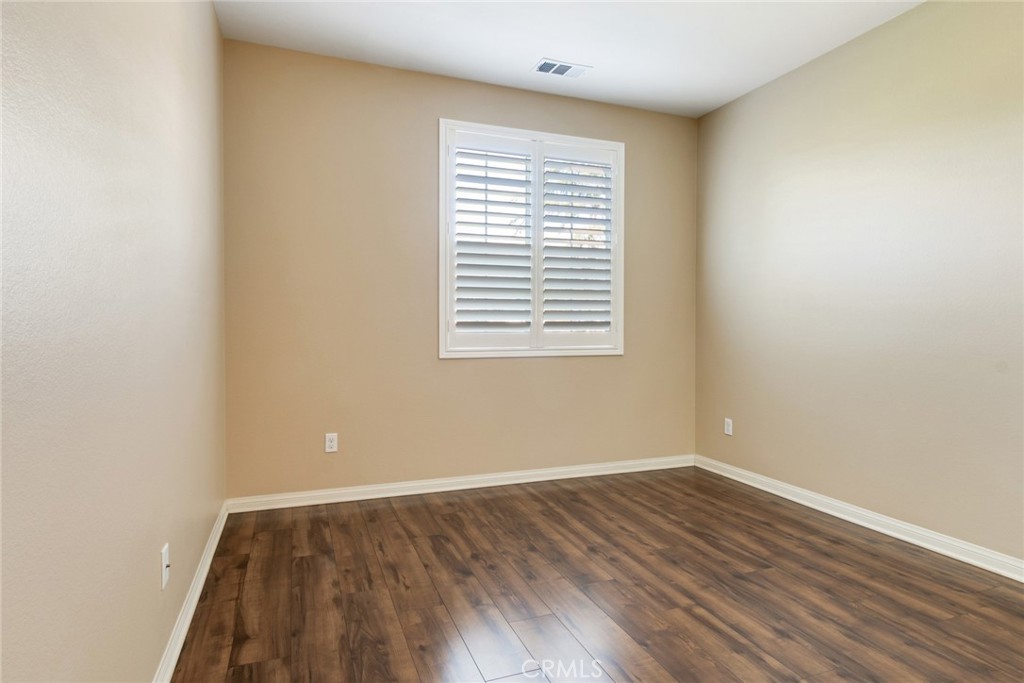 7903 Chaparral Drive Highland, CA 92346 - Photo 23 of 28 wooden floor in an empty room with a window