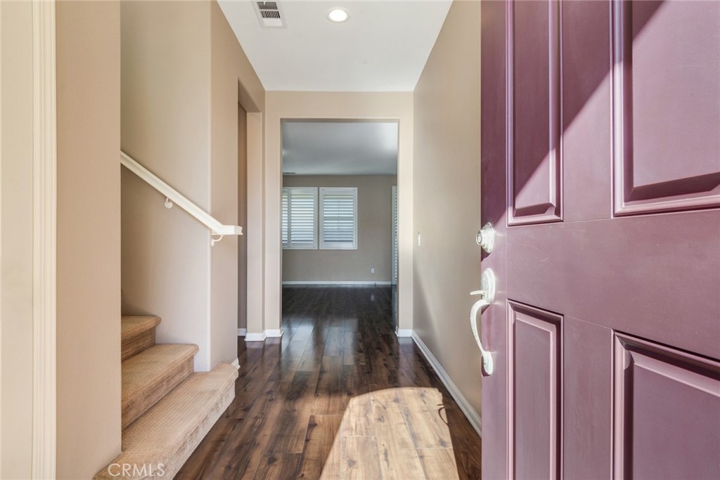 7903 Chaparral Drive Highland, CA 92346 - Photo 3 of 28 a view of a hallway with wooden floor and staircase