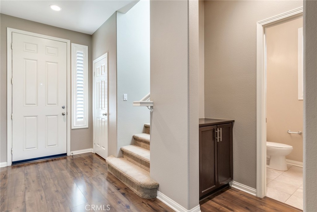 7903 Chaparral Drive Highland, CA 92346 - Photo 4 of 28 a view of a bathroom with toilet shower and wooden floor