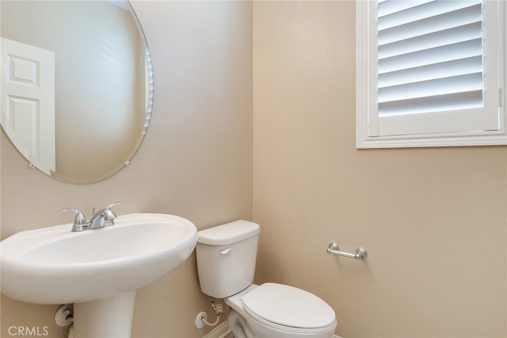 7903 Chaparral Drive Highland, CA 92346 - Photo 5 of 28 a bathroom with a sink mirror and toilet