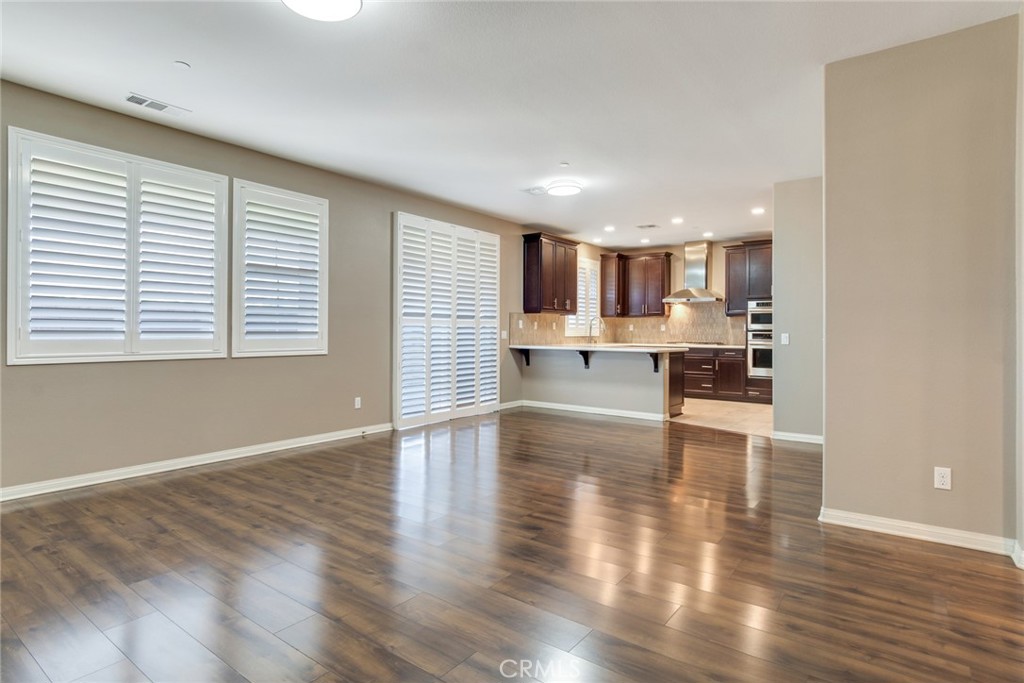 7903 Chaparral Drive Highland, CA 92346 - Photo 9 of 28 a view of kitchen and kitchen with wooden floor