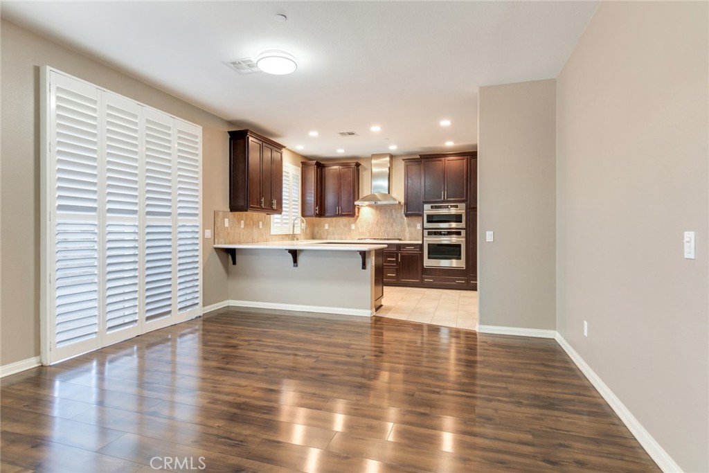 7903 Chaparral Drive Highland, CA 92346 - Photo 10 of 28 a view of kitchen with wooden floor and electronic appliances