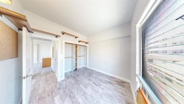 a view of a hallway with wooden floor and windows
