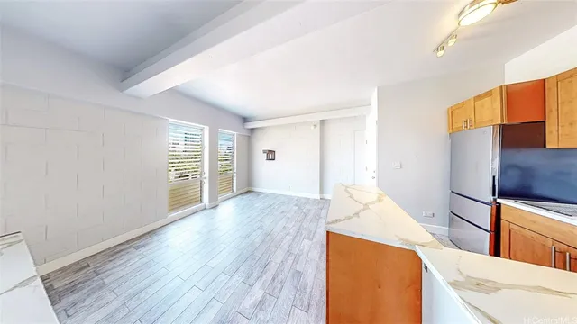a view of a kitchen with wooden floor and electronic appliances