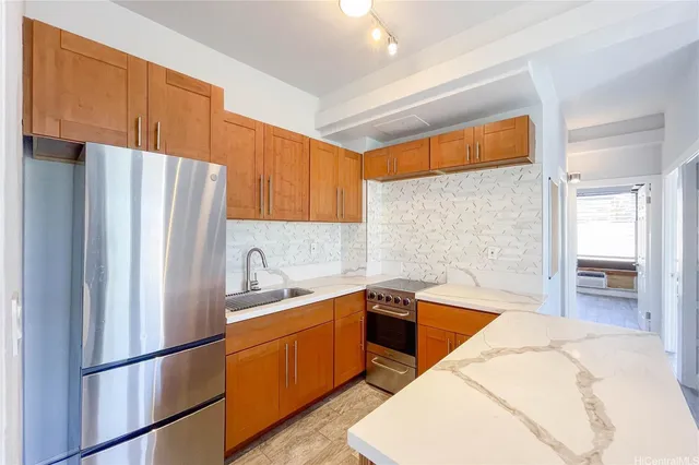 a kitchen with stainless steel appliances granite countertop a refrigerator sink and cabinets