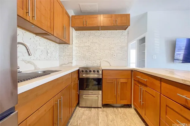 a kitchen with stainless steel appliances a stove and a refrigerator