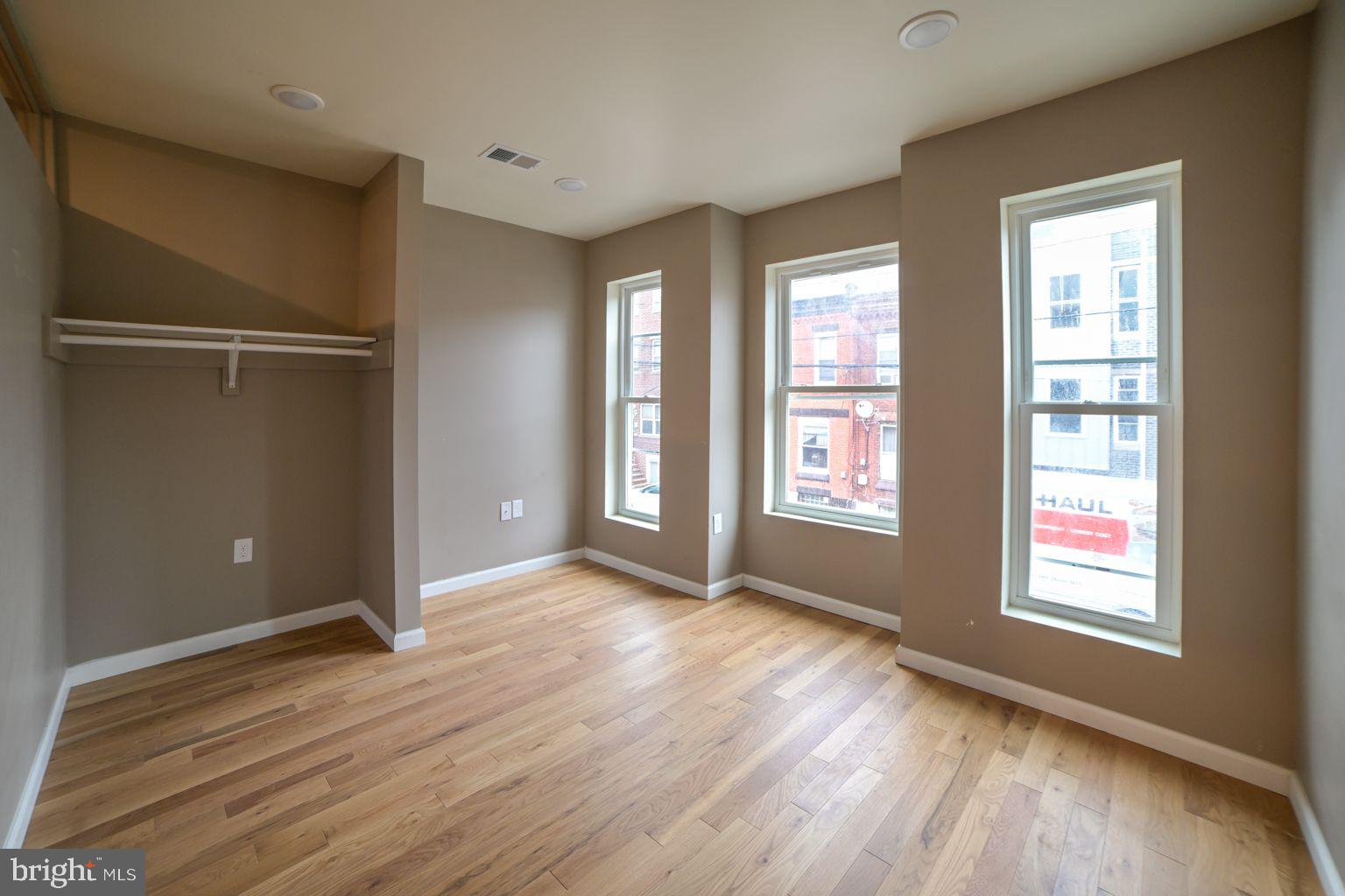 1806 Willington Street, Unit 2 Philadelphia, PA 19121 - Photo 8 of 16 an empty room with wooden floor and windows