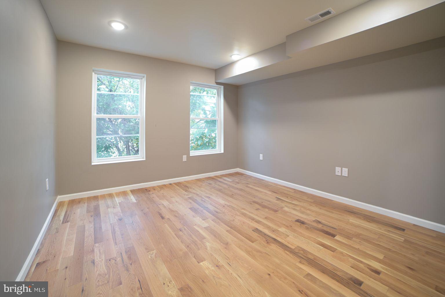 1806 Willington Street, Unit 2 Philadelphia, PA 19121 - Photo 10 of 16 an empty room with wooden floor and windows