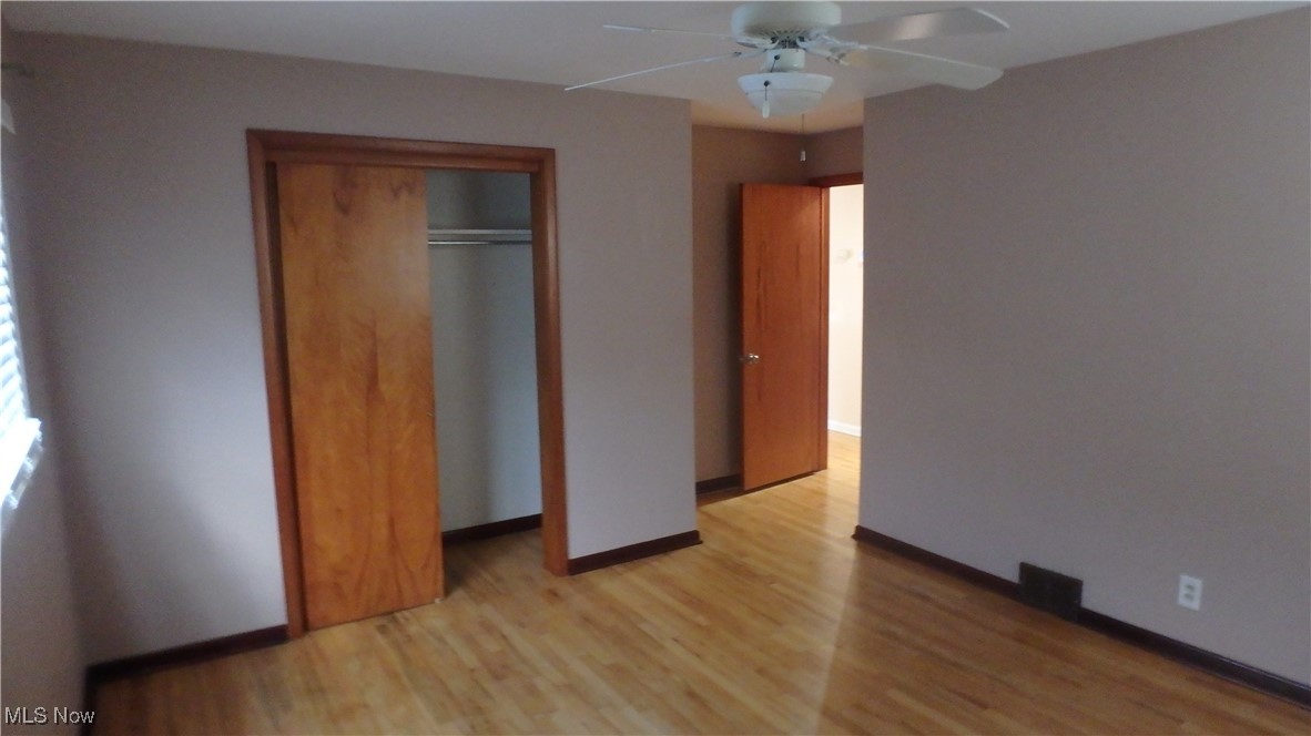 2901 Dentzler Road Parma, OH 44134 - Photo 16 of 25 Unfurnished bedroom with light wood finished floors, a closet, and a ceiling fan