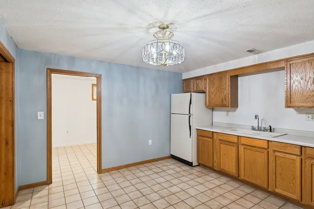 a view of a kitchen with a sink and dishwasher cabinet