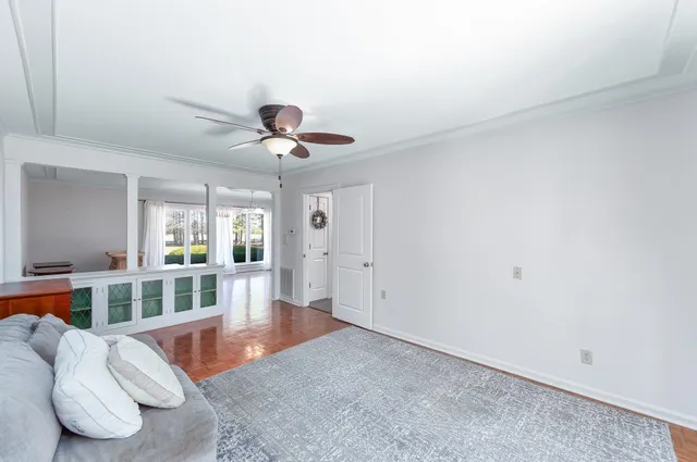 a living room with furniture and a wooden floor