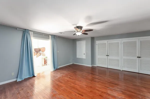 a view of a room with wooden floor and natural light